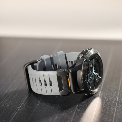 Smartwatch with gray band on a dark surface