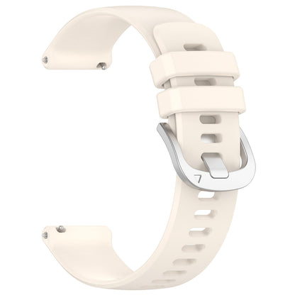 cream watch strap with silver clasp on a white background