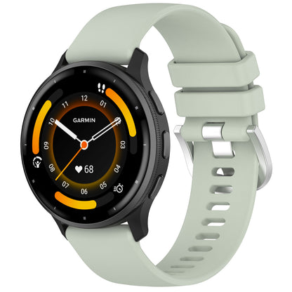 Garmin with a light green band on a white background