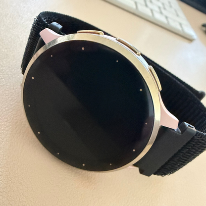 Garmin with black band on a beige surface