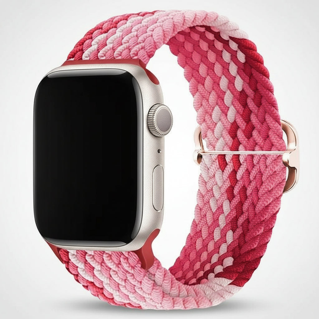 Apple Watch with a pink and white braided strap on a white background